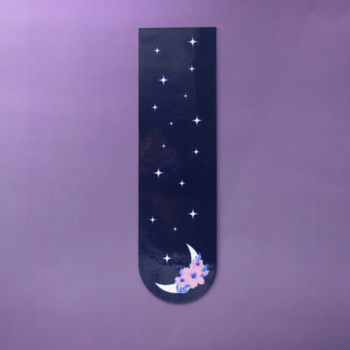 Celestial bookmark featuring a white crescent moon with pink flowers and white stars on a dark navy blue background, with a rounded bottom edge.