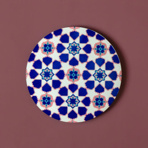 Circular MDF coaster with a dense floral geometric pattern in pink and purple.
