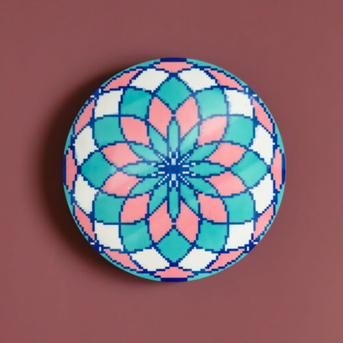 Circular MDF coaster with a colorful kaleidoscopic floral rosette in pink, teal, and white.