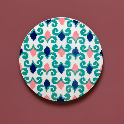 Circular MDF coaster featuring a navy and cream interlocking geometric pattern.