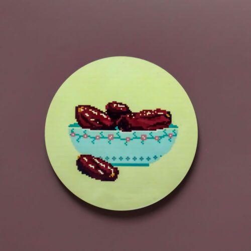 Circular MDF coaster featuring a blue bowl of dates.