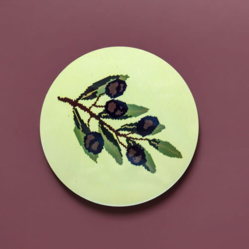 Circular MDF coaster featuring an olive branch on a yellow background.